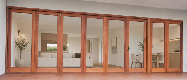 A wide set of natural timber bi-fold doors.