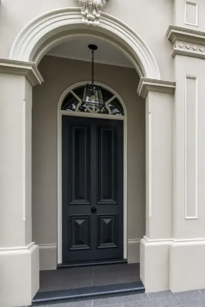 Detailed black timber entrance door and fanlight