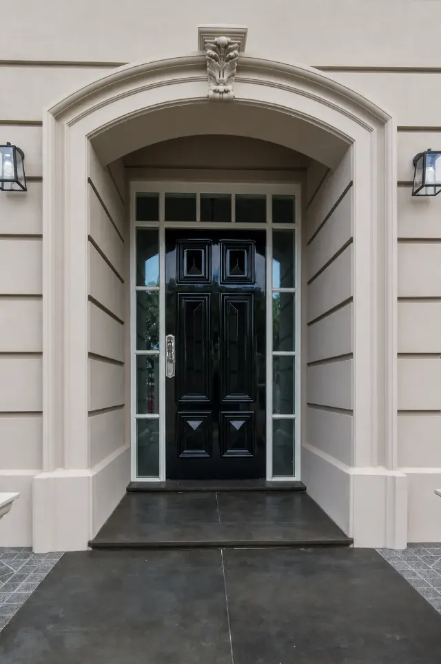 Black timber entry door with glazed sidelights and transom.